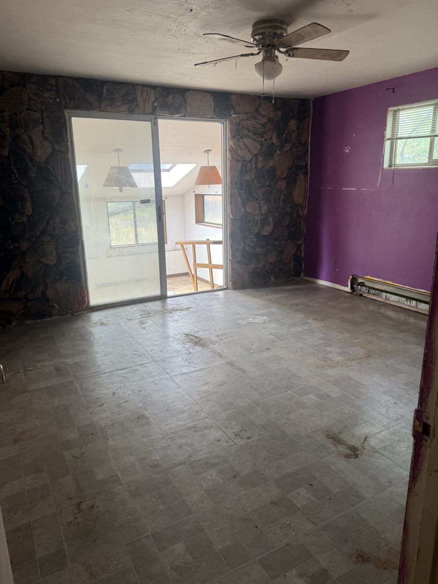 Empty bedroom with worn flooring in a Reno 89519 house before sale